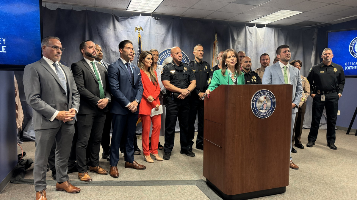 Miami-Dade State attorney at the lectern on Monday, announcing details of sex-related arrests during the World Cup.
